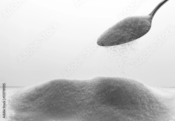 Fototapeta refined sugar poured from spoon