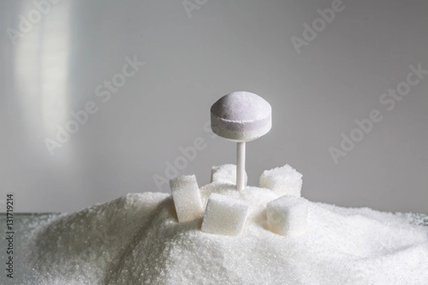 Fototapeta dextrose lollipop on sugar cubes and heaps of refined sugar