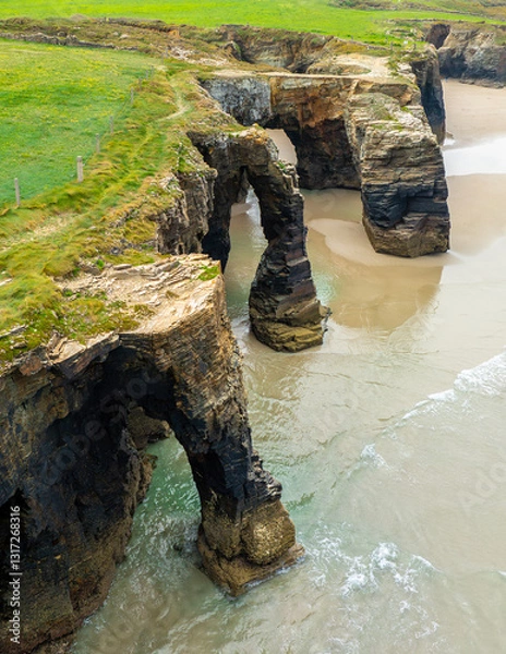 Obraz Natural rock arches Cathedrals beach, Playa de las Catedrales at Ribadeo, Galicia, Spain. Famous beach in Northern Spain Atlantic. Natural rock arch on Cathedrals beach in low tide