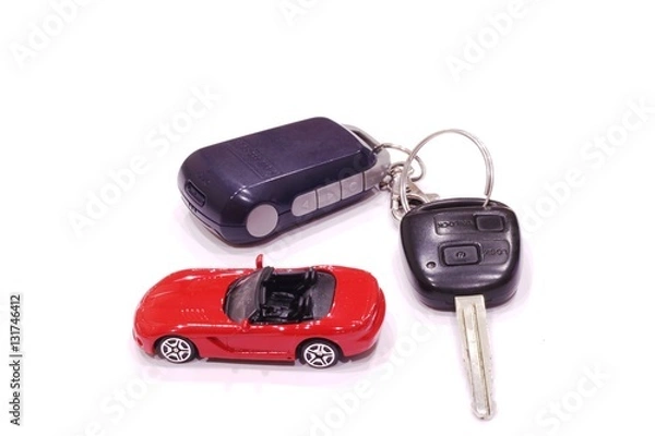 Obraz Red toy car and black car keys on white background