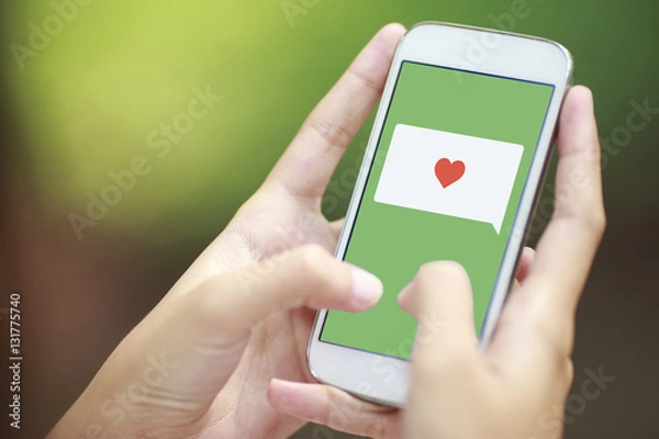 Obraz smartphone with speech bubble and heart
