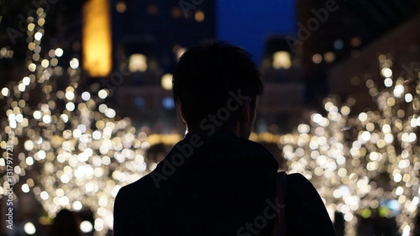 Obraz  Silhouette of Asian guy back, alone in Christmas illumination l
