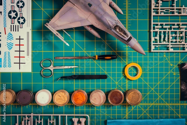 Obraz view from the top of paint, tools and plastic scale model