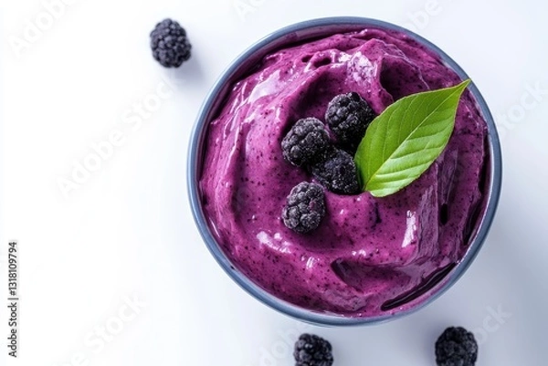 Fototapeta Delicious vibrant purple berry sorbet with fresh blackberries and green leaf garnish served in a bowl