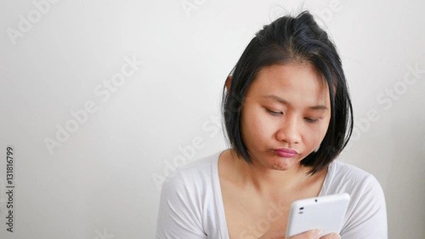 Fototapeta Upset stressed woman holding cellphone disappointed with message