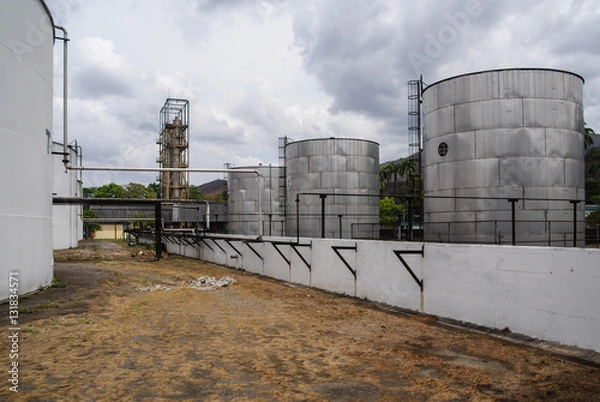 Obraz An industrial lot with big structures in the background.