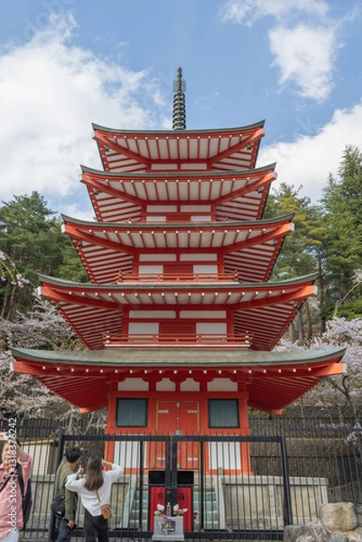 Fototapeta Fujiyoshida, Yamanashi, Japan - APR 17, 2024: Arakura Fuji Sengen Jinja Shrine. Mt Fuji with red pagoda in cherry blossom sakura in spring season .
