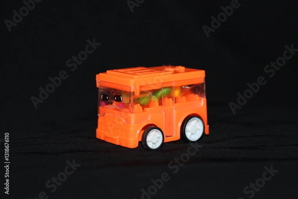 Fototapeta a children's toy in the shape of a vehicle on a black background