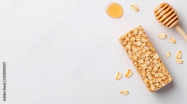Fototapeta Wholesome Delight: A granola bar is elegantly presented alongside its companion ingredients, a drizzle of honey, and oats