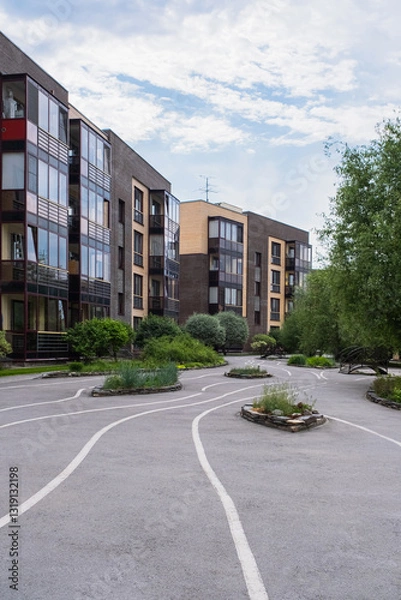 Fototapeta Green yard of low-rise houses in summer