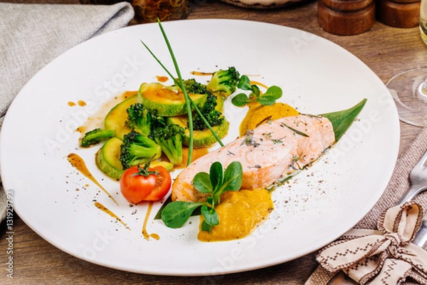 Fototapeta grilled salmon steak on a round white plate