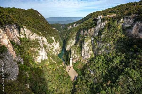 Fototapeta Scenic view from Zhangjiajie glass bridge, the world's longest and highest glass bridge. Green grand canyon with elevator in Wulingyuan area, Zhangjiajie, Hunan, China.