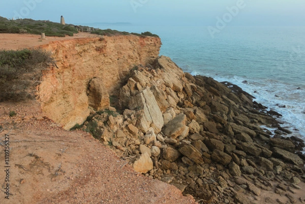 Obraz Crumbling cliff face overlooking the ocean at dawn
