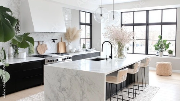 Obraz Beautiful open concept kitchen featuring waterfall edge marble countertop and modern design elements