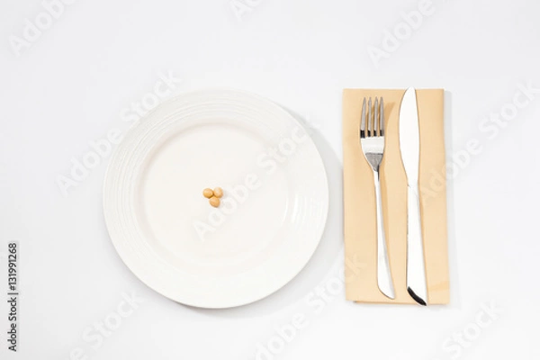 Fototapeta One Soybean on plate with fork and knife.