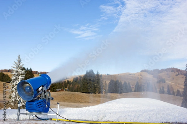 Fototapeta Cannon fires snow on the ski slopes