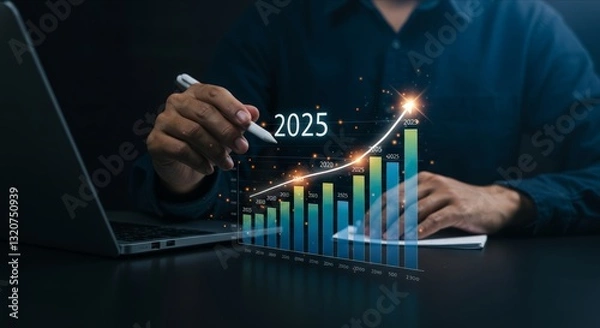 Fototapeta Hand with pen over 2025 bar graph, laptop.
