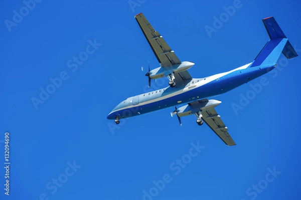 Obraz wide-body plane is flying in blue sky