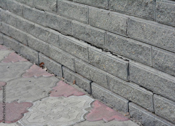 Fototapeta Horizontal cracks in house basement foundation wall. Wet spot and crack in foundation.