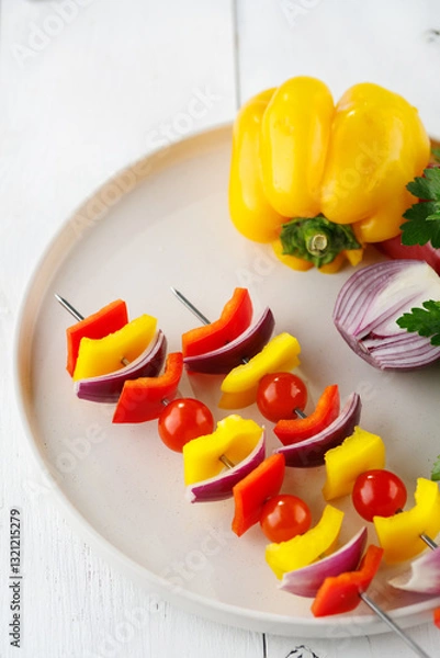 Fototapeta Vegetable kebab on skewers on a light wooden background