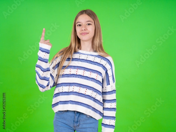 Fototapeta beautiful teen girl wearing striped sweater smiling and looking friendly, showing number one or first with hand forward, counting down