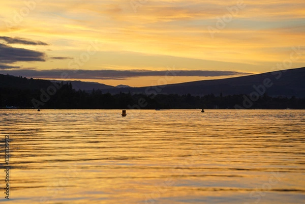 Fototapeta View over Loch Lomond from Balloch during sunset. It is part of the Loch Lomond and The Trossachs National Park 