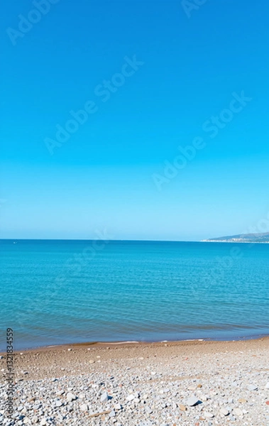Fototapeta A beach view with a blue ocean and a sandy shore.
