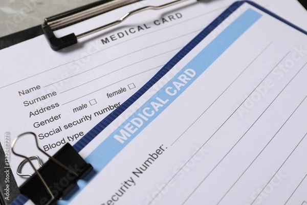 Fototapeta Medical card forms on grey background, closeup