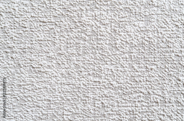 Fototapeta A white woolen fabric background with a woven texture, ideal for wallpaper or textile design. The soft, grainy linen pattern provides ample copy space, offering a simple and elegant backdrop for desig