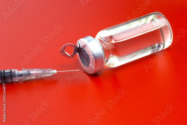 Obraz Vial with insulin hormone and  single use insulin syringe (pen) lying near the ampule. Set for diabetic problem. Red background.
