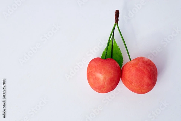 Obraz Artistic gourmet chocolates and decorative cherries on a white background with copy space for text  

