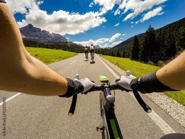 Obraz Group of cyclist on mountaionous road. Original point of View POV, view in first person. Focus on hands of cyclist.