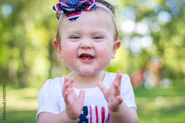 Obraz Festive one year old girl in the park on the 4th of July