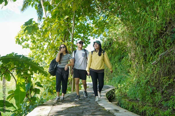 Obraz group of happy young asian indonesian people walking together on the walk path in the park