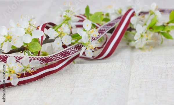 Fototapeta May 4, Independence Day of Latvia, greeting design with flowers and Latvian flag.