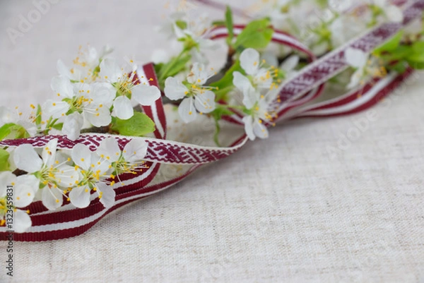 Fototapeta May 4, Independence Day of Latvia, greeting design with flowers and Latvian flag. Greeting card or banner.