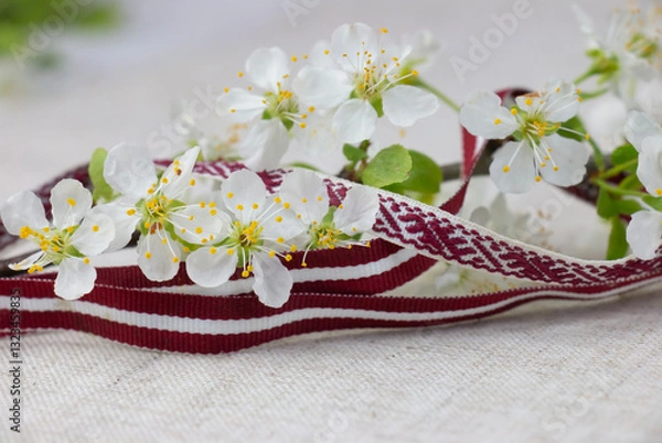 Fototapeta May 4, Independence Day of Latvia, greeting design with flowers and Latvian flag. Greeting card or banner.