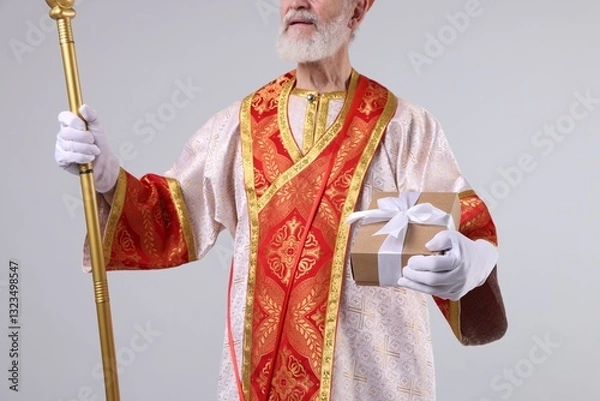 Obraz Saint Nicholas with gift on light grey background, closeup