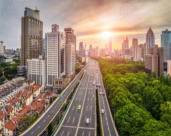 Fototapeta Cityscape with modern buildings and highway at sunset in Shanghai