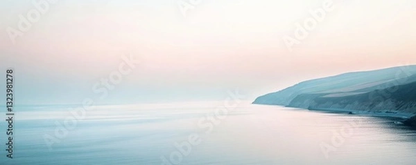 Obraz The calm ocean meets a coastline under a soft pastel sky