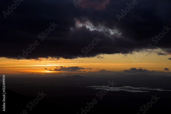 Fototapeta Autumn sunset light with clouds in blue sky with mountain landscape between the trees in horizontal chemtrails