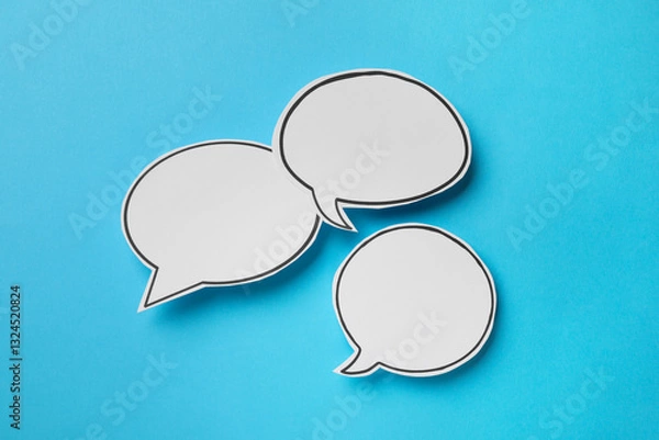 Obraz Blank speech bubbles on light blue background, top view. Space for text