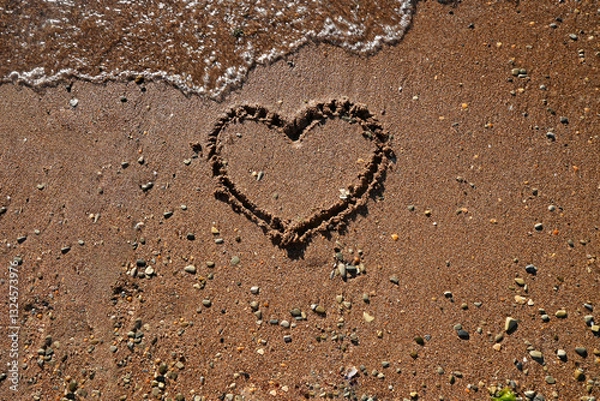Fototapeta heart drawn on beach sand with soft blue wave in the background. Concept of relaxation and love for sea