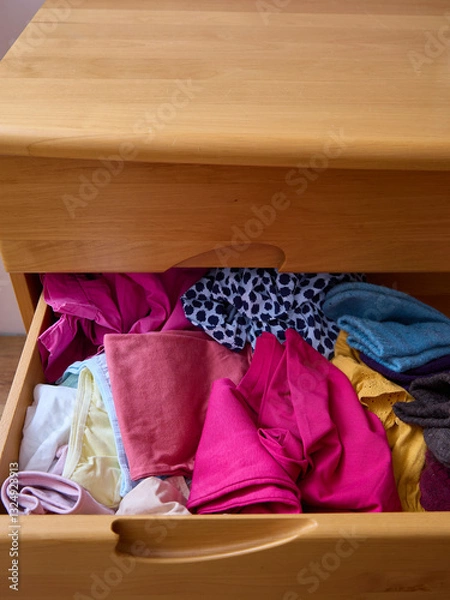 Obraz The linen from the drawer is crumpled and lies in a pile. Clutter and problems of space organization.