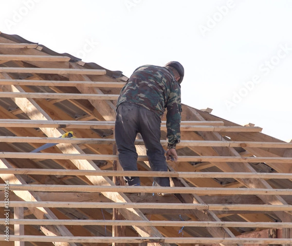 Fototapeta workers working on the roof