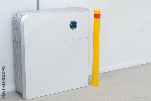 Fototapeta Large white battery for solar energy storage installed in a garage with safety post