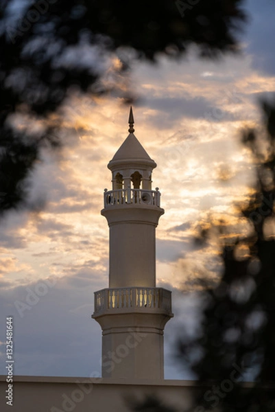 Fototapeta The top of the mosque tower with cloudy sky