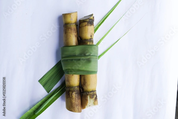 Fototapeta A bunch of sugar cane is cut into small pieces