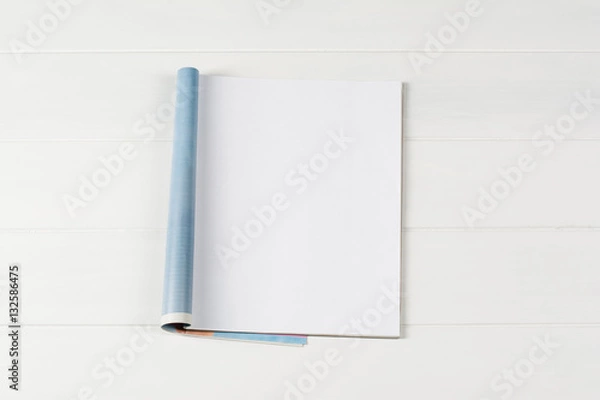 Fototapeta Mock-up magazine or catalog on wooden table. Blank page or notepad on wood background. Blank page or notepad for mockups or simulations.