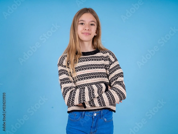 Fototapeta Portrait of charming beautiful caucasian girl wearing striped sweater standing confidently smiling toothily with hands folded